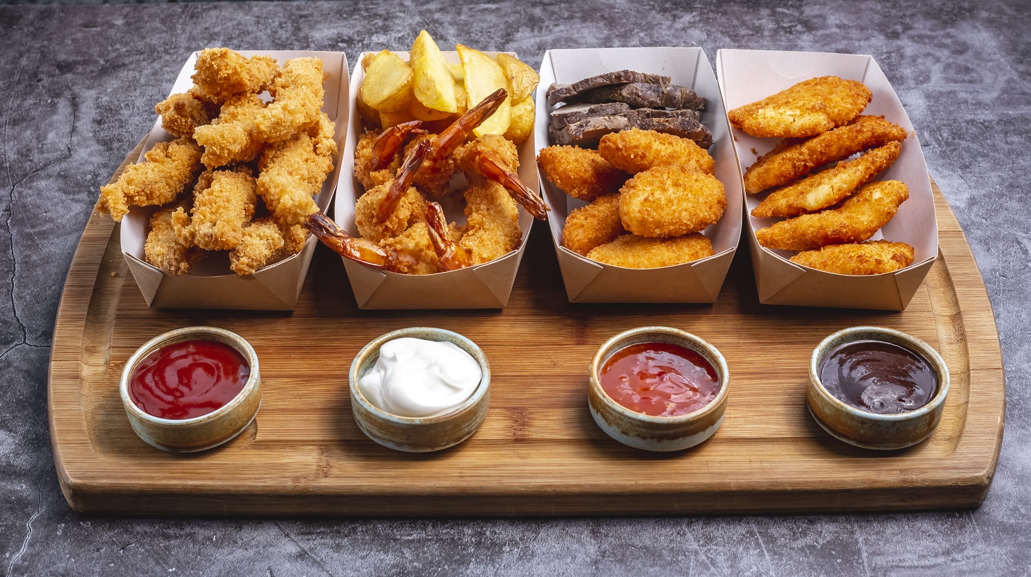 four boxes of nuggets with chicken prawn cheese and fish with four sauce
